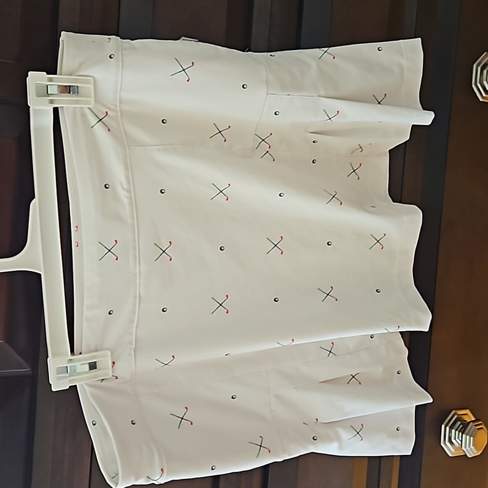 Golf skirt  white   clubs and balls   side pleet  white shorts under  side pocke